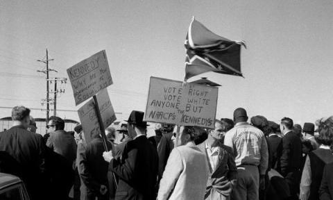 john_f_kennedy_assasination_anti-kennedy_protestors_await_jfk's_arrival_at_love_field_airport_dallas_on_november_22_1963