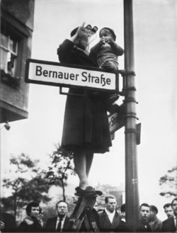 berlin_wall_a_woman_and_a_child_wave_across_the_wall